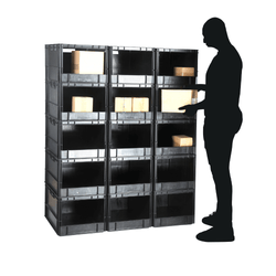 Stacked pick wall of grey plastic stackable open fronted euro storage container on a plain white background, propped with cardboard boxes stored within. 60 litre capacity. 600 x 400 x 320 mm. With a black male silhouette on the right hand side of the pick wall to illustrate the scale of the storage boxes