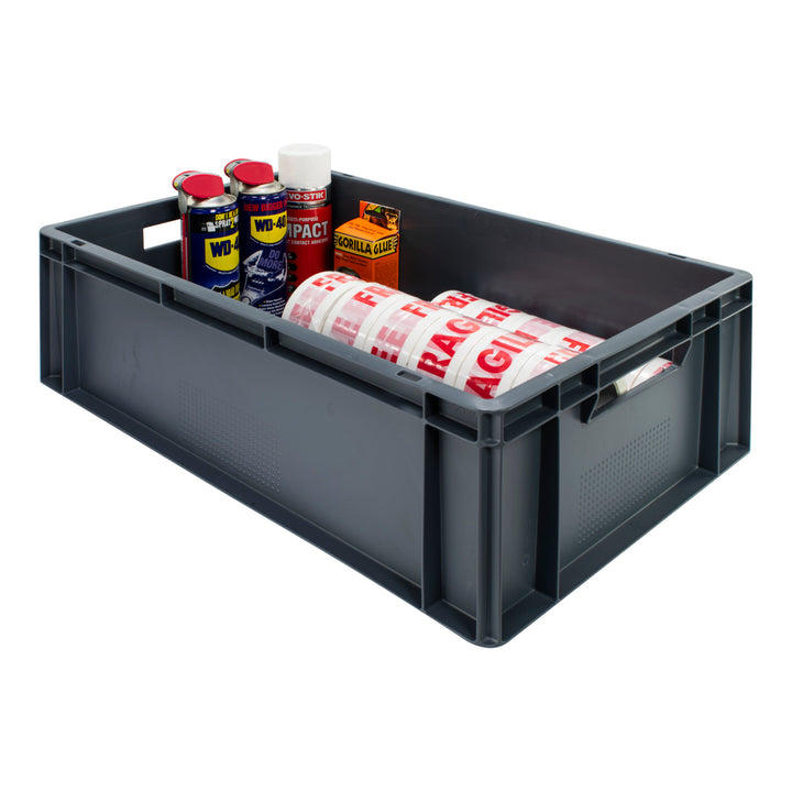 Grey plastic stackable euro storage container on a plain white background. 40 litre capacity. 600 x 400 x 200 mm.  Box is filled with 2 cans of WD-40, impact adhesive, gorilla glue and fragile tape